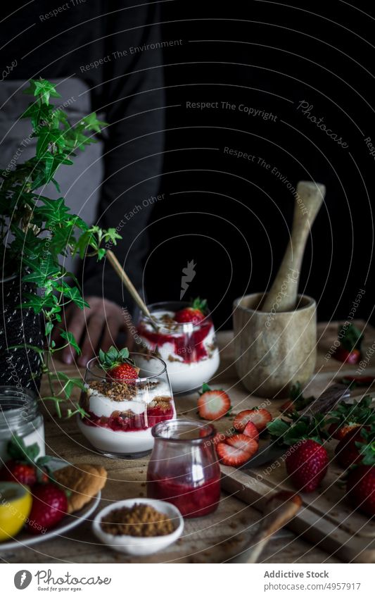 Chef cooking tasty dessert with fresh berries in dark kitchen strawberry cheese food hand cuisine vitamin sweet person healthy slice gastronomy dairy homemade