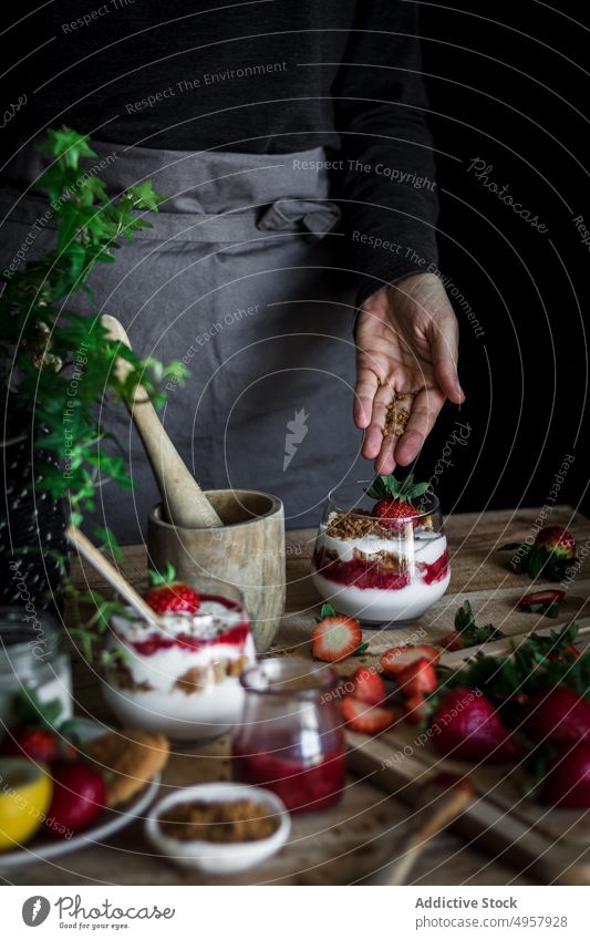 Chef cooking tasty dessert with fresh berries in dark kitchen strawberry cheese food hand cuisine vitamin sweet person healthy slice gastronomy dairy homemade