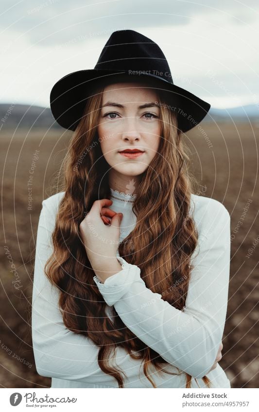 Young hipster woman in the countryside girl nature young person lifestyle hat summer model beauty hair outdoors casual background caucasian face stylish retro