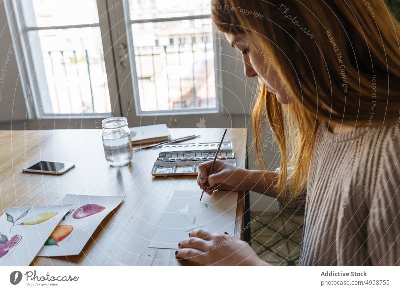 Young girl painting watercolor drawings woman art young caucasian studio creative female painter picture artist student craft designer workshop hobby artwork