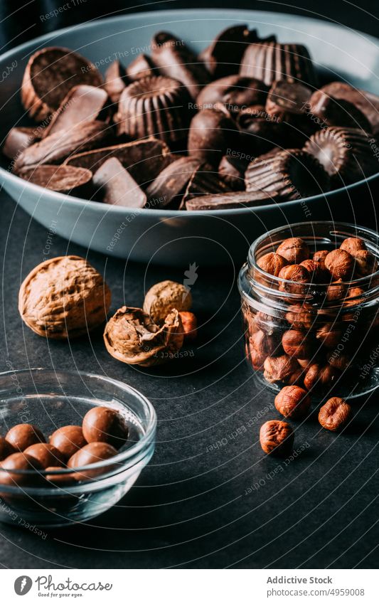 Delicious chocolate sweets and nuts placed on table dessert handmade walnut hazelnut delicious food yummy calorie cocoa composition gourmet ingredient assorted