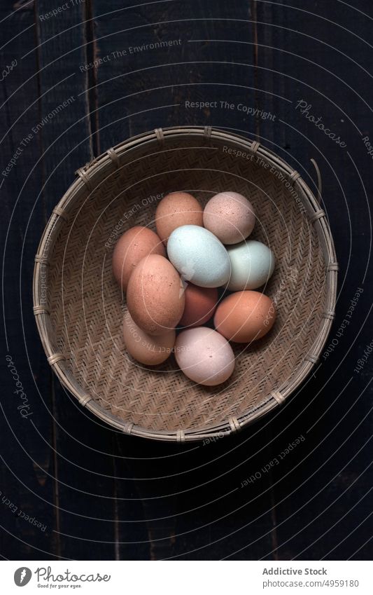 Top view of basket with eggs natural heap pile food ingredient raw chicken organic nature fresh health protein wicker season traditional breakfast wood cuisine