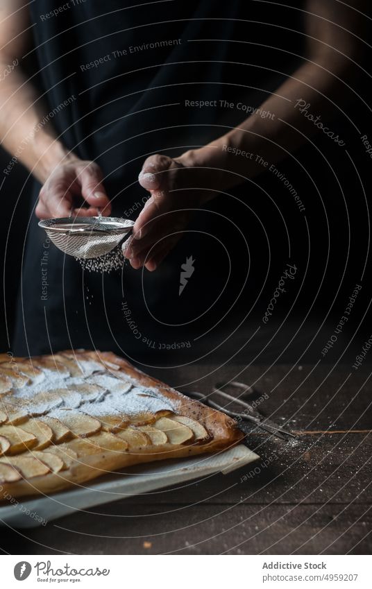 Crop baker sprinkling pie with powdered sugar bakery apple sprinkle cover dessert frangipane food fruit gourmet crust sweet delicious plate fresh sieve utensil