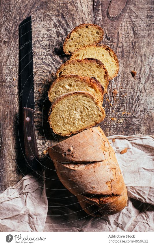 Sliced wholegrain bread scattered on wooden table slice fresh loaf baked nutrition rustic food kitchen bakery homemade meal ingredient gourmet tasty rye product