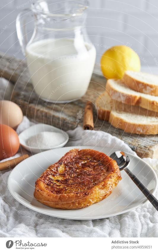 Tasty torrija bread served on table with fresh ingredients in kitchen milk egg sugar cinnamon lemon breakfast food appetizing cutting board delicious toast