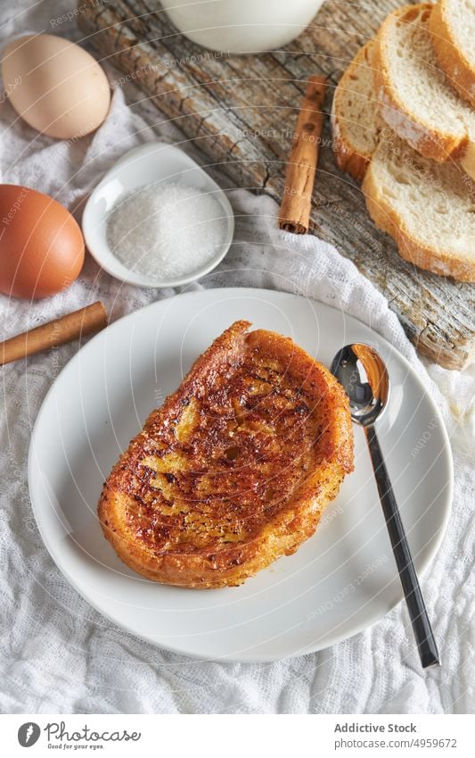 Tasty torrija bread served on table with fresh ingredients in kitchen milk egg sugar cinnamon lemon breakfast food appetizing cutting board delicious toast