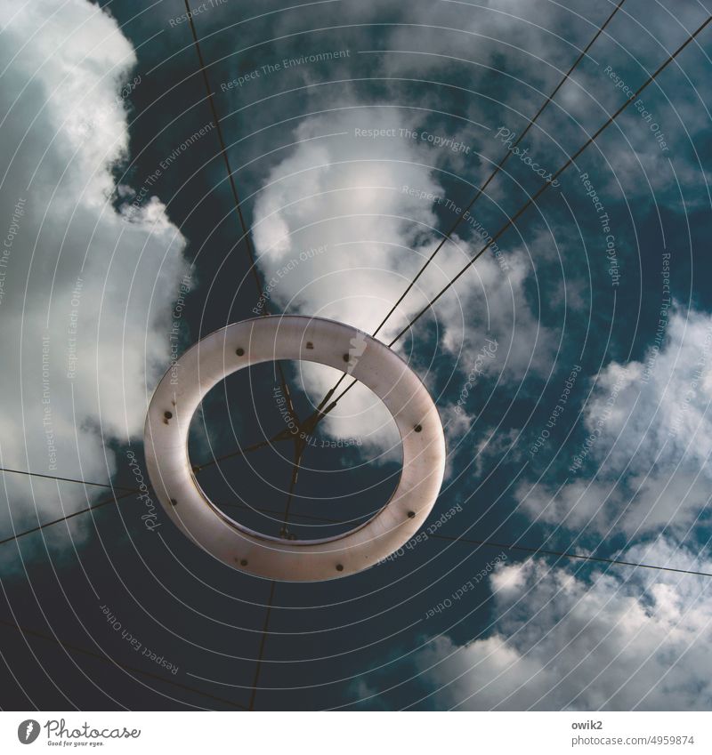 Rostock, Doberaner Platz Street lighting lamps Rings Glass Fluorescent Lights Above Round Suspended Sky Clouds criss-cross wires Cable Tense Firm Blue Day