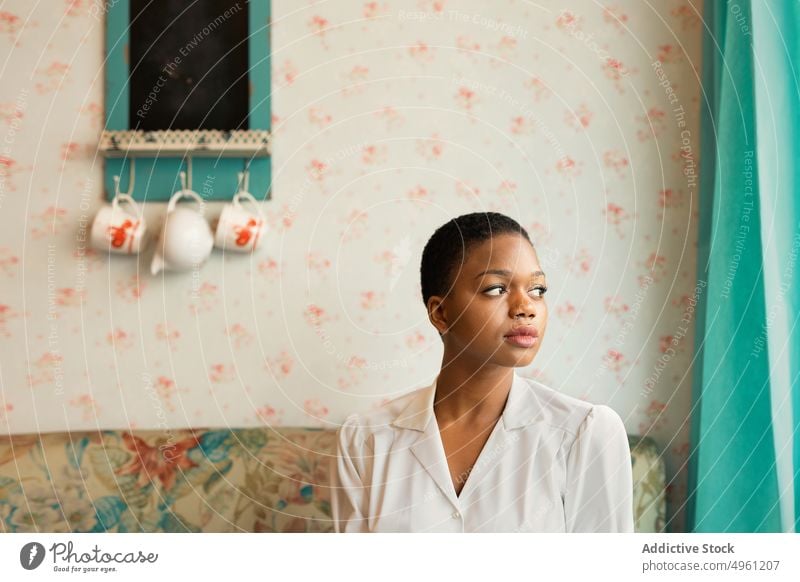 African American woman with short hair lifestyle resting female african american relax apartment comfort home sitting ethnic young thoughtful beautiful pretty