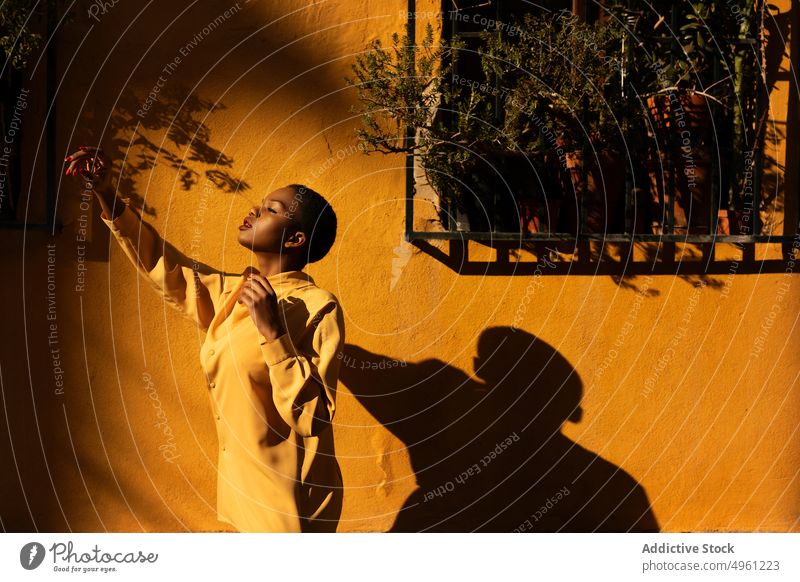 African American woman posing near yellow wall standing lifestyle rest relaxed enjoy female african american carefree femininity positive ethnic young black