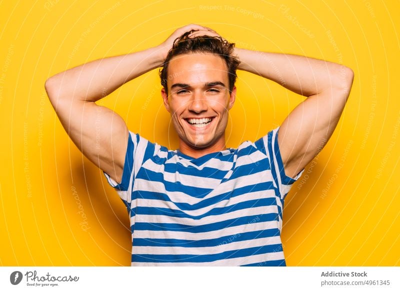 Stylish model with modern haircut on yellow background man fashion trendy soap bubble rebel stripe colorful portrait having fun transparent creative design cool