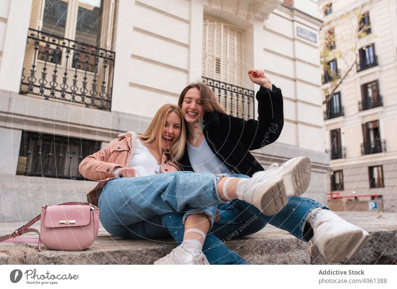 Delighted women having fun together in city friend cheerful carefree enjoy freedom friendship best friend female madrid spain street weekend positive