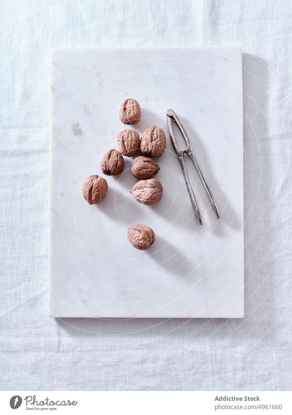 Cracking walnuts view from above shell open white background kernel food seed fruit closeup half macro cracked guy process natural organic ingredient nutrition