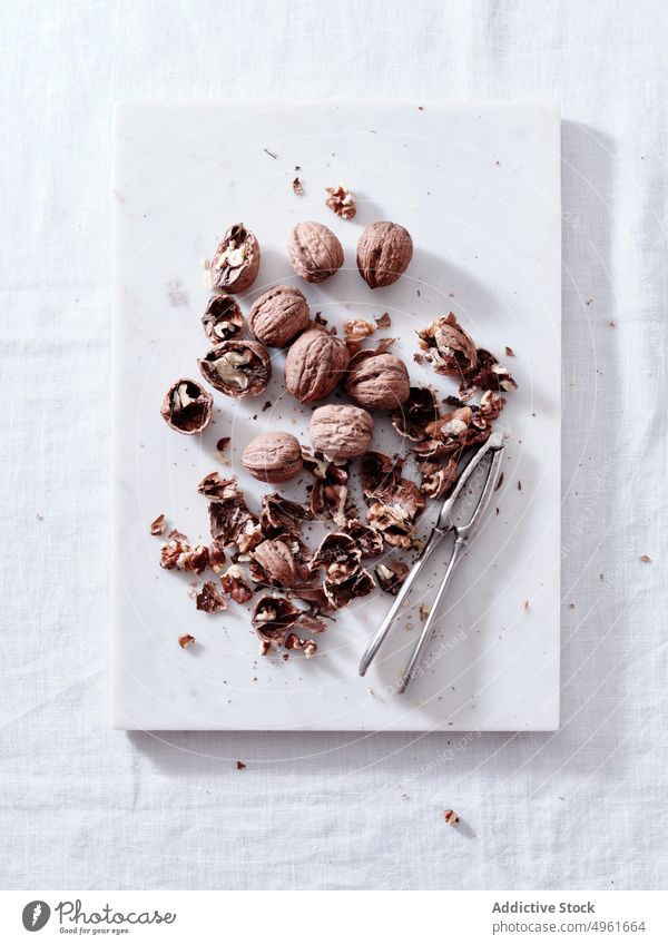 Cracking walnuts view from above shell open white background kernel food seed fruit closeup half macro cracked guy process natural organic ingredient nutrition