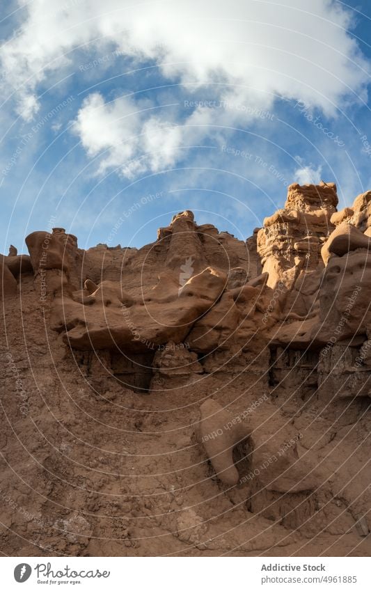 Hoodoos against cloudy blue sky hoodoo sandstone formation daytime arid desert terrain landscape goblin valley state park usa utah united states america rock