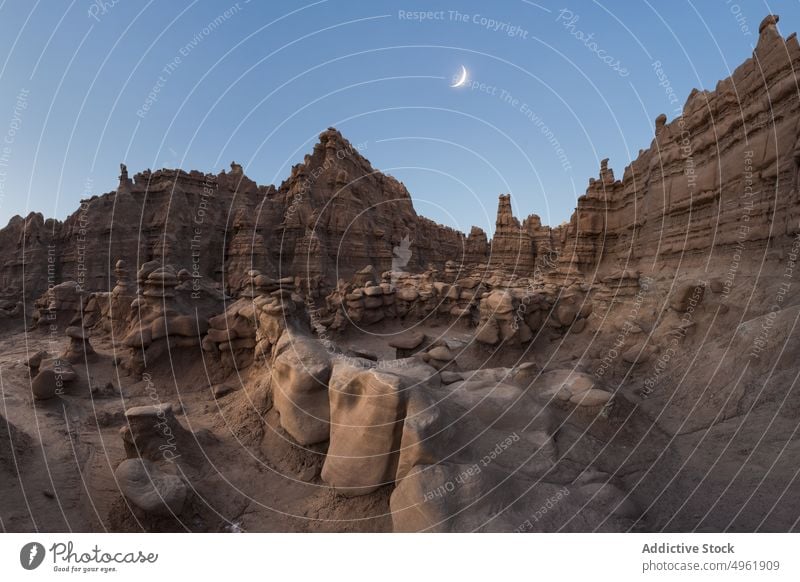 Rock formations against evening sky sandstone hoodoo cloudless sky moon dry cliff crescent desert goblin valley state park utah usa united states america nature