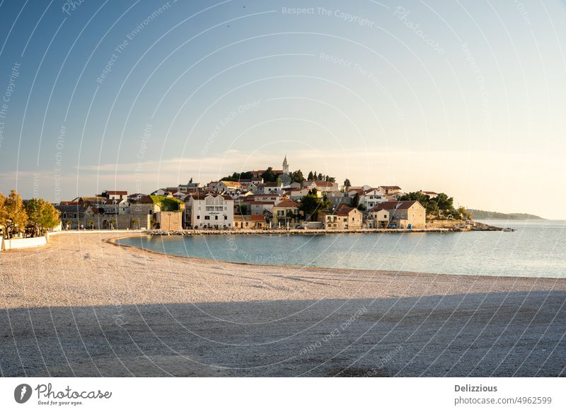 View of Primosten village in Croatia during sunset, no people primosten croatia town beach landscape nobody europe european sand sky blue buildings city