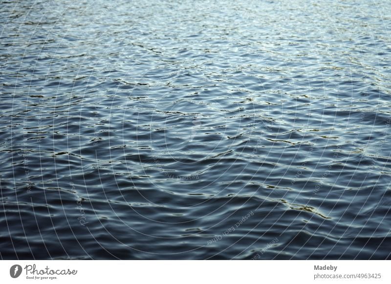 Dark shimmering water surface with light swell of Poyrazlar Gölü near Adapazari in summer sunshine in Sakarya province, Turkey Country life Wetland country lust