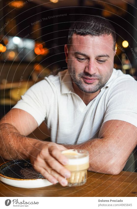 Middle aged man sitting in a bar having breakfast adult african american attractive beverage business businessman casual caucasian caucasian appearance coffee