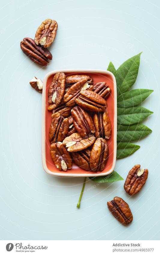 Shelled Pecan nuts in a bowl pecan dry fruit nutrition ingredient healthy cooking baking food omega3 shelled vegan vegetarian fat horizontal overhead closeup