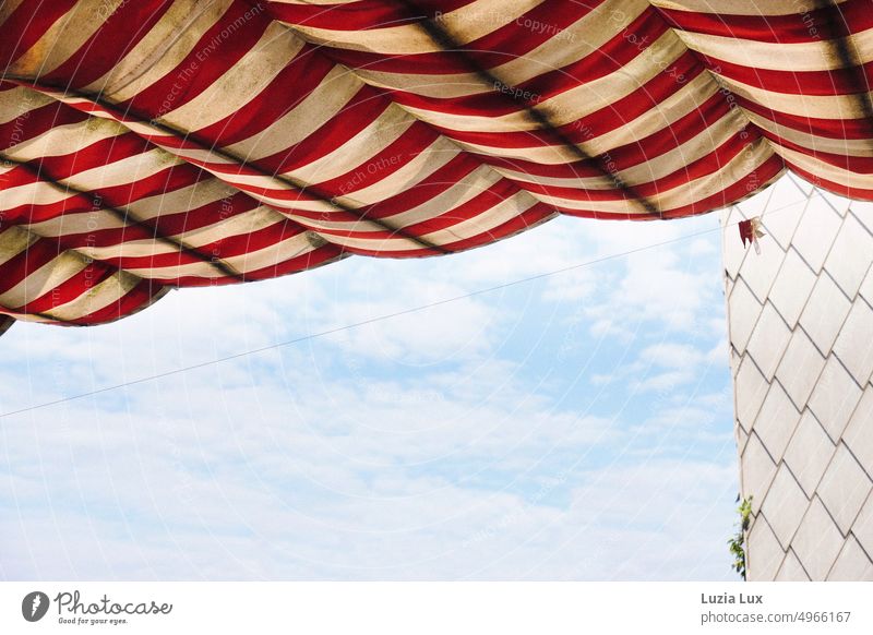 Summer sky light blue with delicate clouds, red and white striped awning with the remains of balloons sunny Sun Bright Structures and shapes Stripe Summery