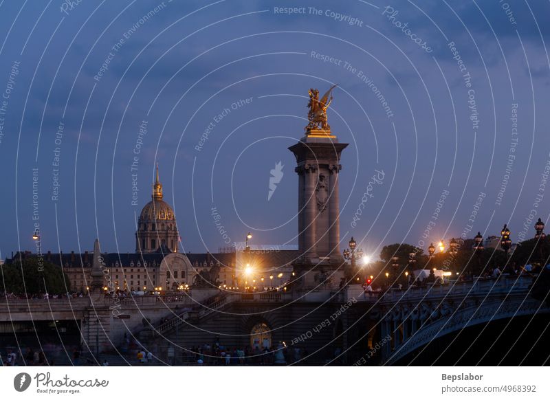 Pont Alexandre III Bridge and illuminated lamp posts at sunset with view of the Invalides. 7th Arrondissement, Paris, France paris france bridge alexander seine