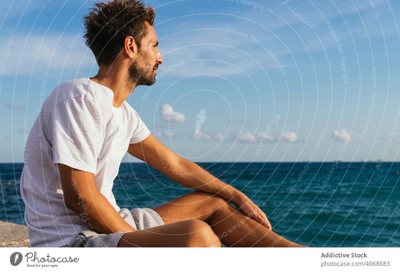 Hispanic sportsman admiring sea during break admire embankment training fitness blue sky summer cloudy male hispanic ethnic adult athlete workout sportswear