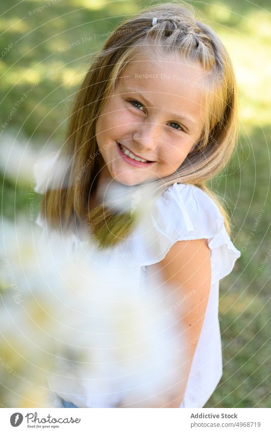 Girl laughing on joke in field girl happy summer nature carefree flower child meadow kid blond cheerful positive optimist sunlight adorable cute weekend glad