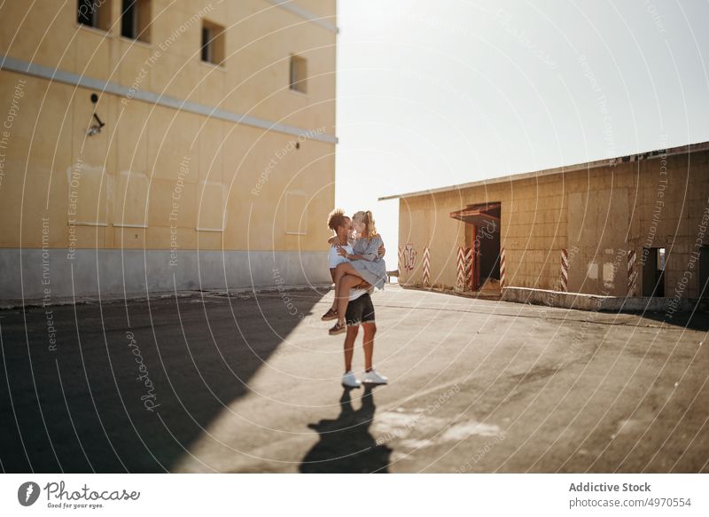 Couple of lovers embracing on the street couple hug kiss together casual male female building relax asphalt embrace affection lifestyle young harmony serene