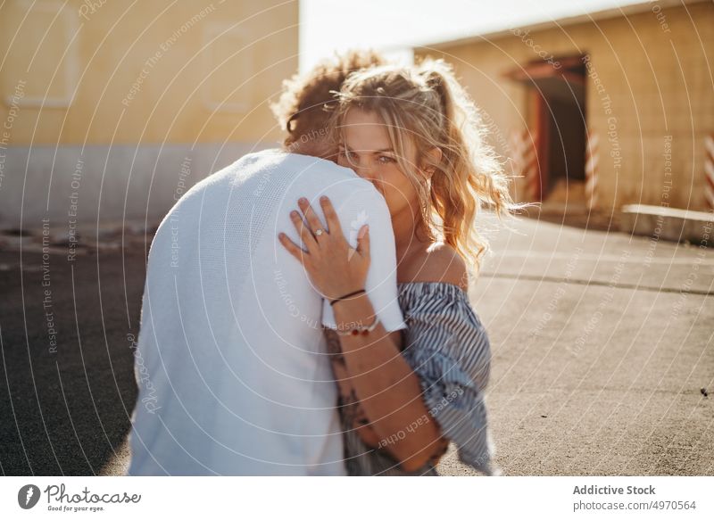 Couple of lovers during embracing on street couple hug kiss together casual male female building relax asphalt embrace affection lifestyle young harmony serene