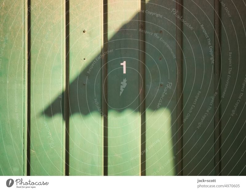 Garage door number 1 Number one Sunlight Shadow Detail Surface Structures and shapes Shadow play Abstract Light and shadow Silhouette Contrast Stripe Green