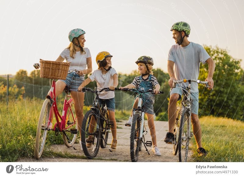 Happy family cycling together in the countryside day healthy lifestyle active lifestyle outdoors fun joy bicycle biking activity bike cyclist enjoying