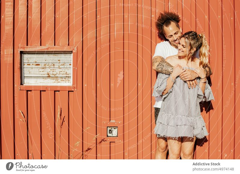 Happy couple embracing on street in sunny day embrace love together happy relationship affection romantic hug gentle hipster casual bonding urban pavement lover