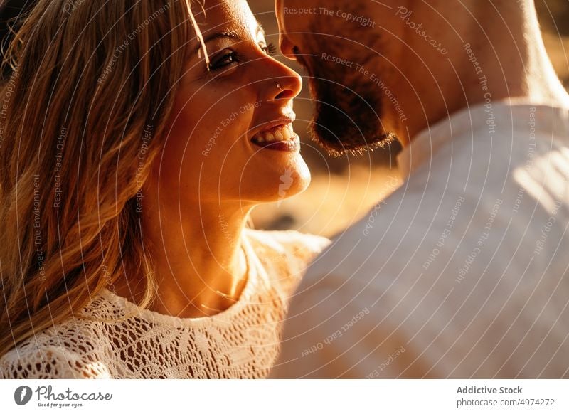 Happy adult couple looking at each other and embracing on street love happy romantic lover relationship hug boyfriend girlfriend smile date idyllic joy fondness