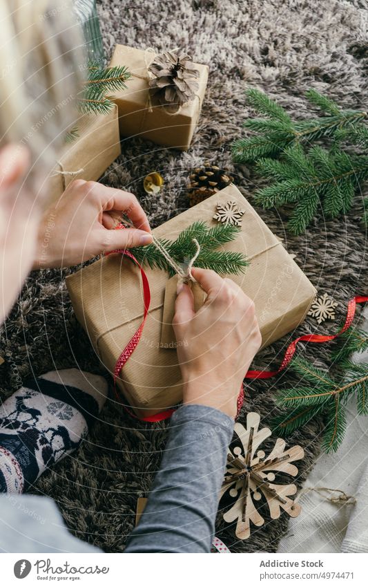 woman wrapping a christmas present indoors surprise box leisure xmas celebration merry gift gold hand handmade decoration decorated paper person gifts holiday