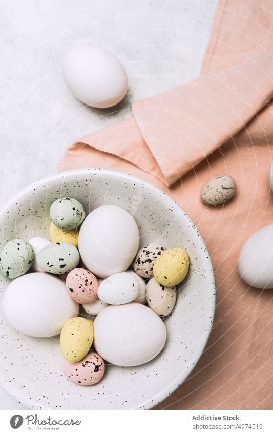 Still life of beautiful painted Easter eggs food table bowl brown colored dotted dyed easter easter egg eggshell cute pink elegant from above gift homemade