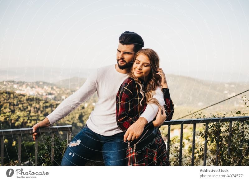 young affectionate couple in the street other walking hugging funny date trip family urban tourism catalonia spain friends handsome male spanish beautiful