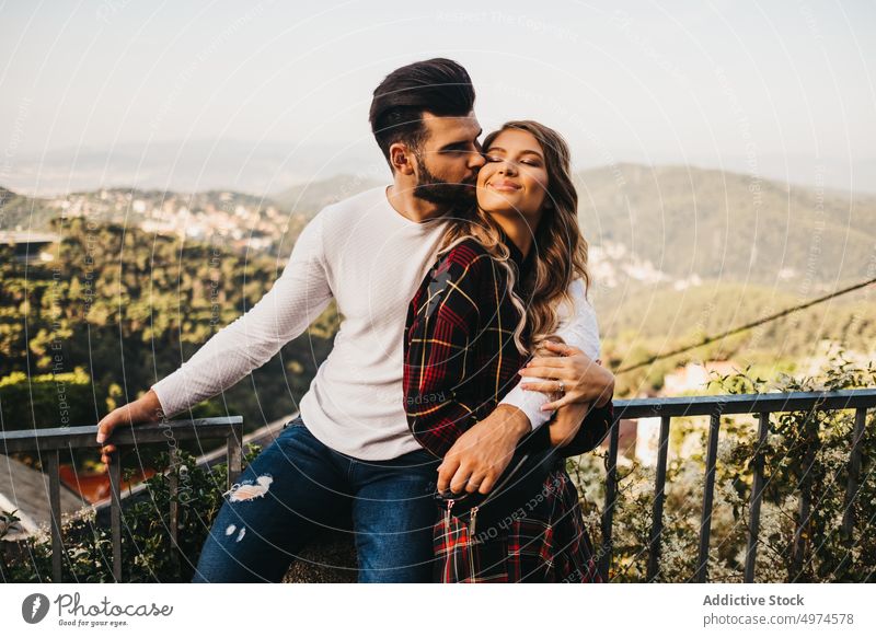 young affectionate couple in the street other walking hugging funny date trip family urban tourism catalonia spain friends handsome male spanish beautiful