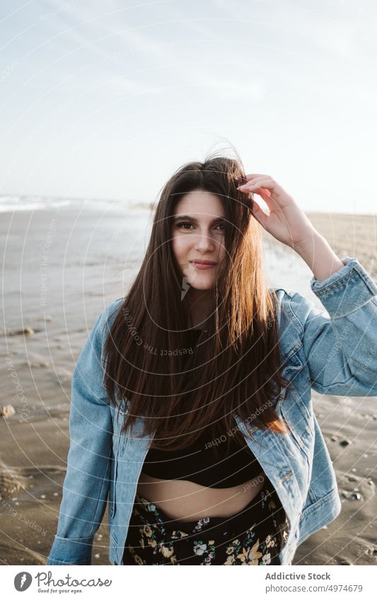 Woman in denim jacket at beach woman portrait beautiful authentic stylish fashion posing jeans clothes young summer model attractive hair outdoor pretty sunny