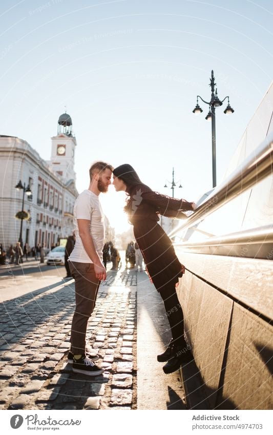 Couple kissing at Puerta del Sol in Madrid couple city madrid sol beautiful young woman happy attractive love vacation female pretty urban family romance