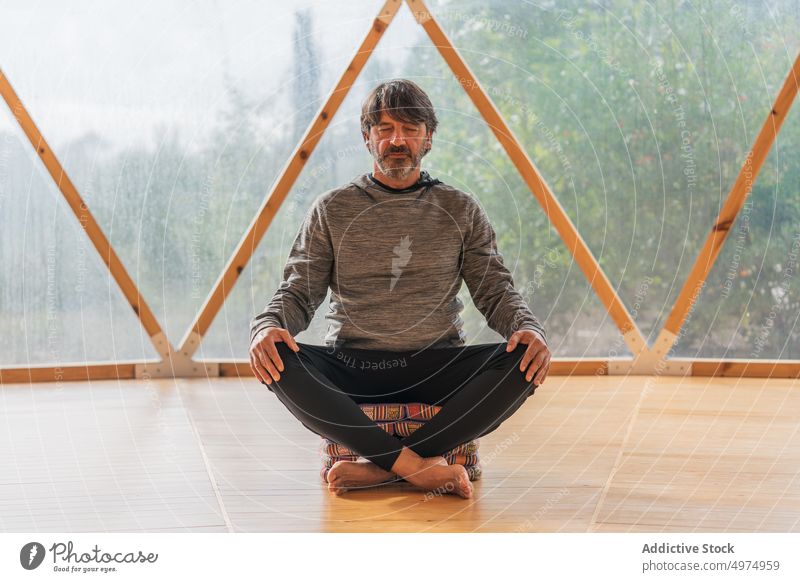 Middle aged bearded man relaxing at spa resort meditate therapy calm zen yoga lifestyle middle aged healthcare wellness quiet balance eyes closed class