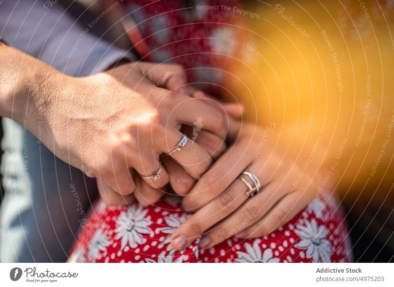 Crop couple holding hands and cuddling in sunlight hug cuddle love affection romantic together relationship style close happy embrace bonding fondness boyfriend