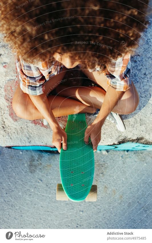 Anonymous tranquil African American woman with penny board on street summer skater cool millennial afro trendy hipster sunny female ethnic african american