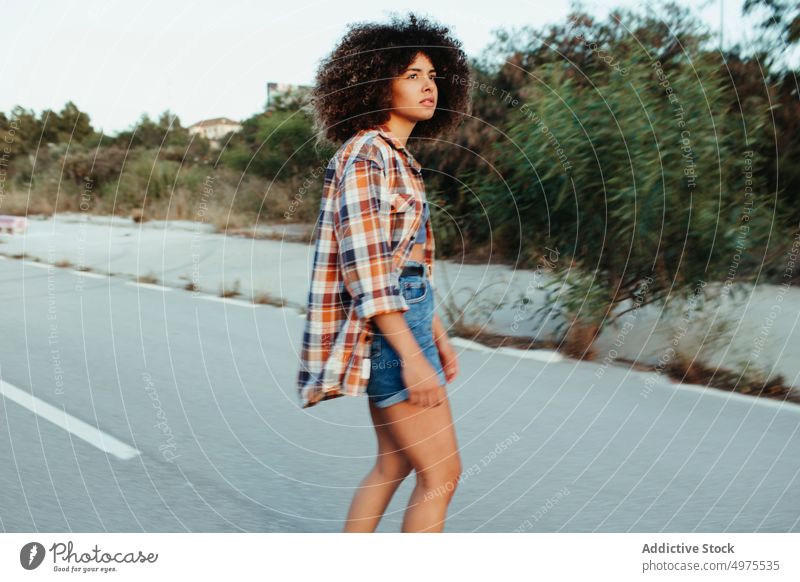 Ethnic woman riding penny board ride sunset road summer hipster skater afro urban female ethnic street trendy tranquil entertain city chill evening sundown