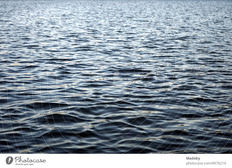 Dark and mysterious shimmering water surface with light swell of Poyrazlar Gölü near Adapazari in summer sunshine in Sakarya province, Turkey Surface of water