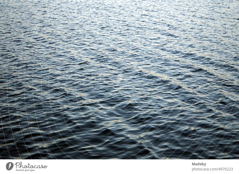 Dark and dangerous shimmering water surface with light swell of Poyrazlar Gölü near Adapazari in summer sunshine in Sakarya province, Turkey Country life