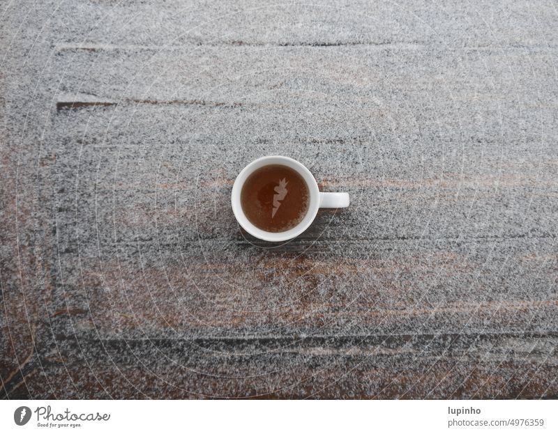 Cup with tea from above, on table lightly covered with snow Tea Tea cup Snow Table sugared Easy Covered November terrace Black tea