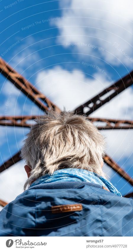 headdress Bridge Railway bridge Steel carrier historical railroad bridge Worm's-eye view Woman Rear view Exterior shot Colour photo Railroad Sky