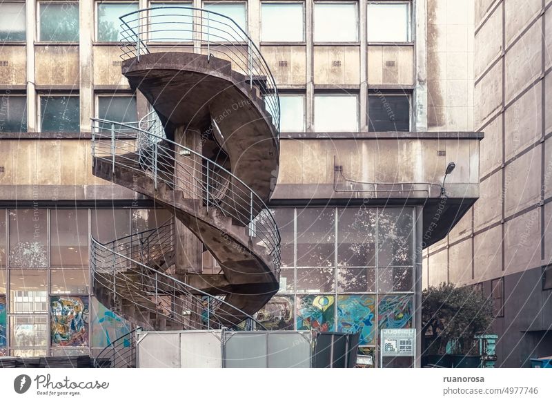 Spiral staircase next to an old two-story building, dirty and painted Winding staircase Building Old Dirty Window Painted decrepit worn-out Derelict Steps