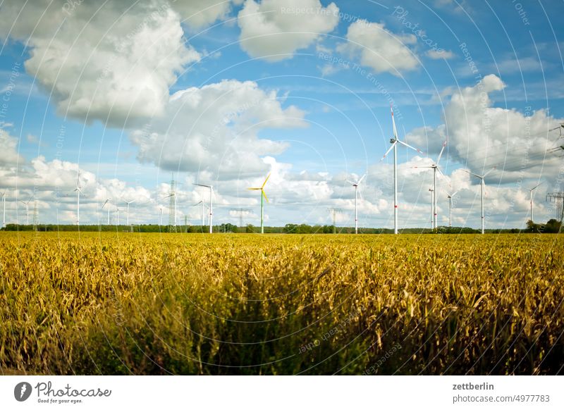 Wind turbines behind farmland acre altocumulus Plain Energy energy revolution Renewable energy Field Far-off places cumulus cloud Sky background Horizon Climate