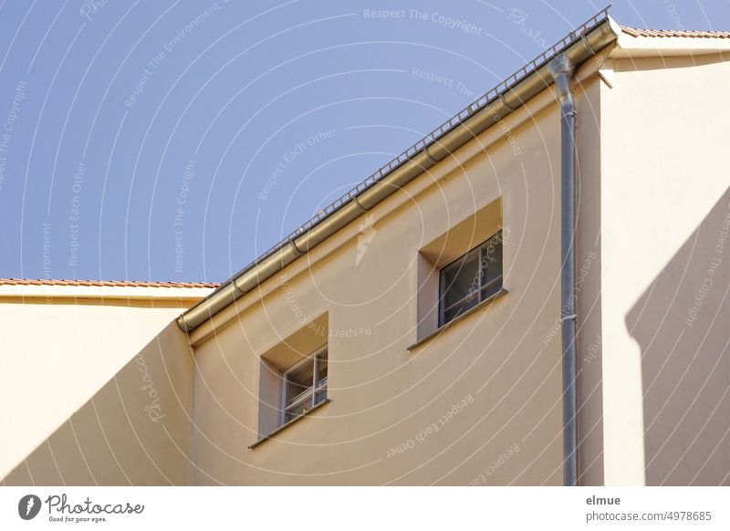 View of two small windows on the shady side of an apartment building / rental prices Apartment Building Window dwell Rental prices rent brake rent control